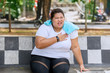 © Creativa Images - Overweight woman having heart attack at park