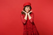 © ViDi Studio - Portrait of smiling young woman in lace dress, cap holding hand near face, looking camera isolated on bright red background in studio. People sincere emotions, lifestyle concept. Mock up copy space.
