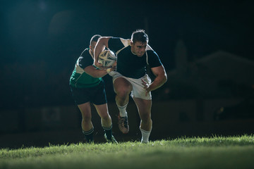 Wall Mural - Rugby player running with ball for making score