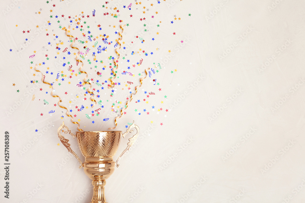 Trophy and confetti on light background, top view with space for text. Victory concept - obrazy, fototapety, plakaty 