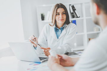 Doctor consulting patient. Patient sitting at doctor office. Diagnostic, prevention of diseases, healthcare, medical service, consultation or education.