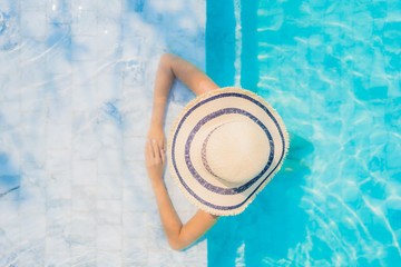 Portrait beautiful young asian woman happy smile relax in swimming pool for travel vacation