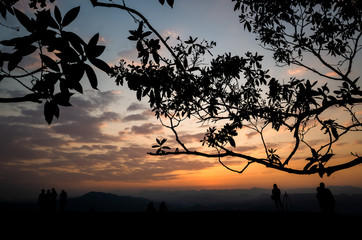 silhouette of people at the top of hill