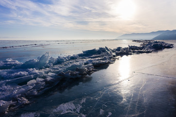 Blue and cold ice of Lake Baikal. Hummocks and heaps of ice