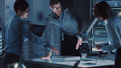 Poster - Diverse Team of Engineers with Laptop and a Tablet Analyse and Discuss How a Futuristic Robotic Arm Works and Moves a Metal Object. They are in a High Tech Research Laboratory with Modern Equipment.