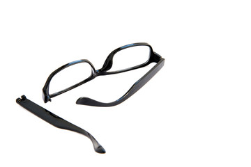 Broken eye glasses, isolated on white background. Black celluloid frame.