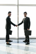 © F8  \ Suport Ukraine - Full length side view of asian businessmen shaking hands in office building with panoramic glasses