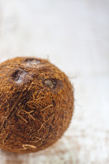 Wall Mural - whole coconut on a white wooden background.