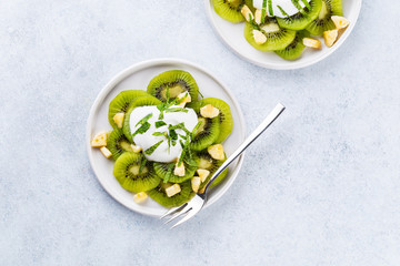 Wall Mural - Kiwi salad with caramelized bananas. mint leaves and fresh yohgurt