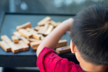 Wall Mural - Kid playing wooden sticks block.