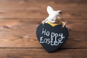 easter greeting card with bunny on wooden background