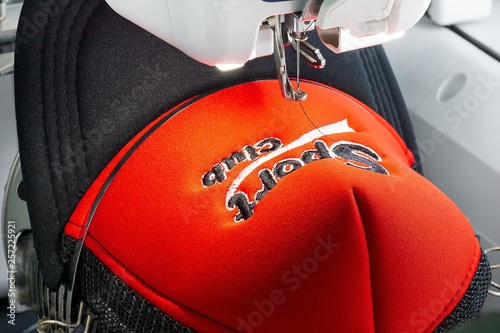 Fotografía Close up picture of red cap on the hoop of embroidery machine