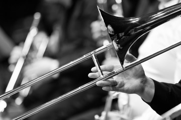 Wall Mural - Hand of man playing the trombone in black and white