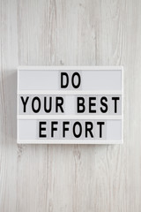 Modern board with 'Do your best effort' words over white wooden background, top view. Overhead, from above. Flat lay.