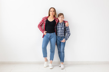 Wall Mural - Family, mothers day and teenager concept - Portrait of mother and son on white background