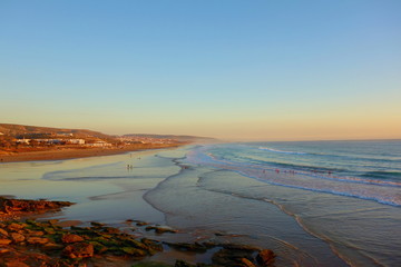 Sunrise over coastal village Taghazout in Southern Morocco known as surfing paradise near to Agadir