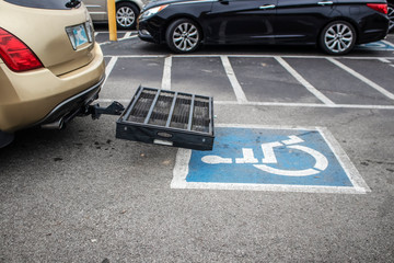 Scooter Lift - Wheelchair Carrier for Car in handicapped parking space in parking lot