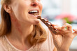 © zinkevych - Woman with rash and reddening neck eating chocolate bar