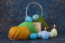 Easter Bread And Blue Easter Eggs In A Basket On Dark Stone Table