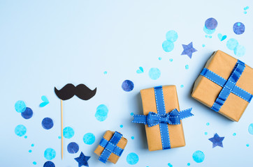 Gift Boxes and Mustache over Blue Background