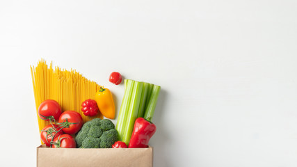 Wall Mural - Paper bag of different healthy food on a table.