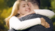 © motortion - Cute woman tenderly embracing husband, romantic date outdoors, feeling love