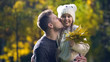 © motortion - Dad holding daughter in funny hat and kissing, leisure together, autumn stroll