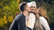 © motortion - Happy parents kiss cheerful daughter in autumn park, wealthy family, wellbeing