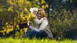 © motortion - Daughter with autumn leaves and woman holding book, happy family embracing