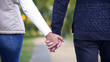 © motortion - Man and woman holding hands back view, living life together, romantic date