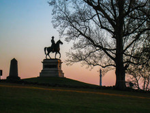 Gorgeous Sunset Silhouetting Statues At Gettysburg National Park In Pennsylvania (USA). 