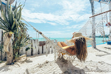 Girl Relaxing In Hammock In Tropical Beach Cafe