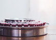 Close-up of a wine glasses  in communion  tray on wooden table with window light, christian background with copy space