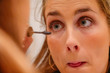 © Alexander - Stockholm, Sweden  A 24 year old woman puts makeup on before going out on a Saturday night.