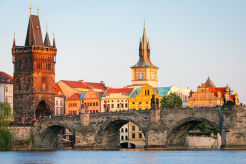 Wall Mural - Scenic view on Vltava rive, Charles bridge and historical center of Prague, buildings and landmarks of old town at sunset, Prague, Czech Republic