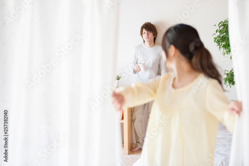 部屋のカーテンを開ける女性とコーヒーカップを持つ男性 Buy This Stock Photo And Explore Similar Images At Adobe Stock Adobe Stock