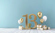 Number 13 party celebration room with gold and white balloons and gift boxes. 