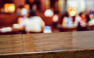 Aufkleber - Wood table with people dinner at restaurant blur background.Empty perspective hardwood bar with blur coffee shop with bokeh light,Mock up for display or montage of product