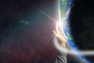 Poster - Touching planet with finger. Nebula dust in infinite space. Mixed media.
