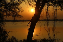 Sun Set On River Bank. In Photography, The Golden Hour Is The Period Of Daytime Shortly After Sunrise Or Before Sunset, During Which Daylight Is Redder And Softer Than When The Sun Is Higher 
