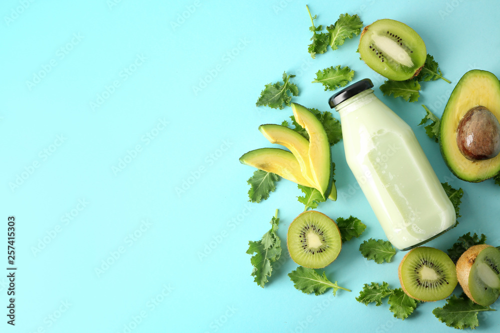 Composition with bottle of smoothie and ingredients on color background