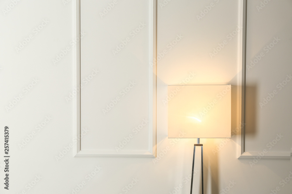 Modern lamp near white wall