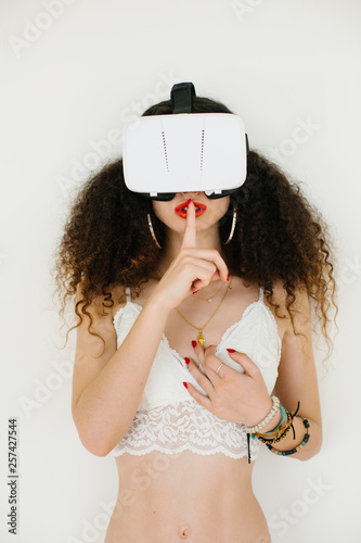 Sexy young woman using virtual reality headset for cybersex ...