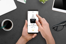 Female Buys A Bag Online With Her Smartphone. Online Shopping Concept