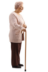 Wall Mural - Elderly woman standing with a cane