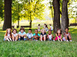 © Evgeniy Kalinovskiy - A large group of preschool children playing in the Park on the grass. The concept of friendship, childhood.Children's day, June 1