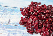 Dried Cranberries And Cherries On Wooden Background