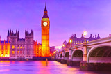 Fototapeta Londyn - View of the Houses of Parliament and Westminster Bridge along River Thames in London at dusk.