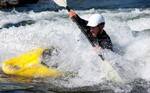 A Male Kayaker In A Playboat Battles The Rapids Of Brennan's Wave, Missoula, Montana.