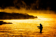 Silhouette Of Man Flyfishing Fishing In River Golden Sunlight Early Morning Fisherman Yellowstone River